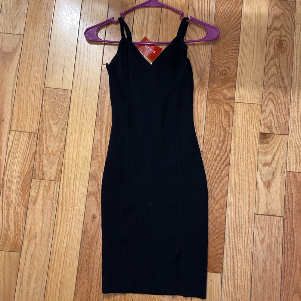 Guess body con dress with a small slit and gold zipper up the back.